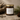 Candle jar labeled 'lodgewood' with natural elements on a stone surface