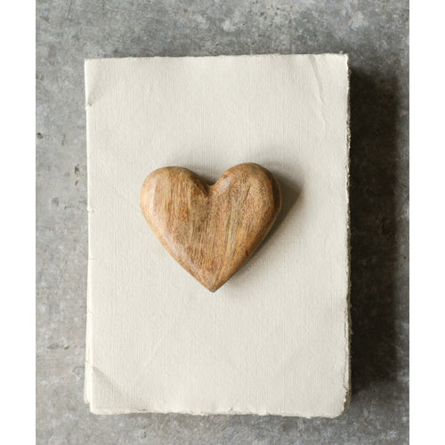Mango Wood Carved Heart on top of a book.