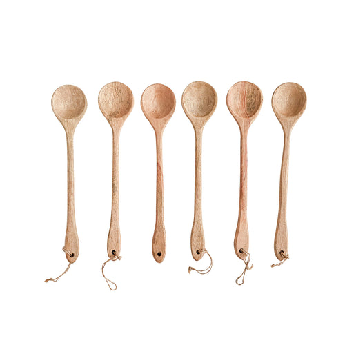 Wooden Spoons with leather straps in a row.