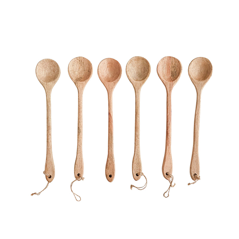 Wooden Spoons with leather straps in a row.