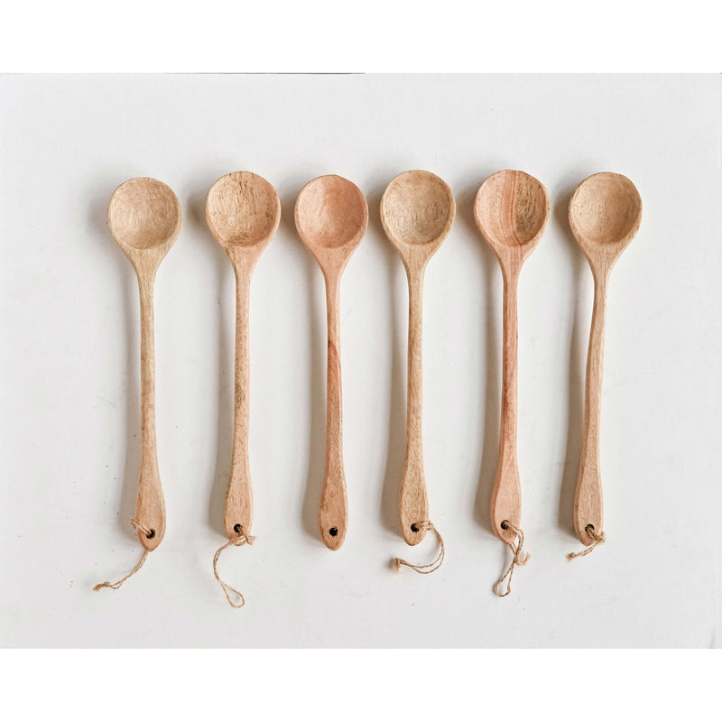 A row of mango wood spoons in the kitchen.