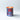 Candle inside a can labeled 'Sirup derable Pur' on a light gray background.