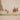 Decorative Christmas trees in ceramic pots on a neutral background