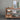 Wooden island with various items against a gray wall