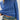Person wearing a blue knitted sweater and jeans with a visible brand belt.