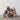 Stack of colorful fabric bags with tassels on a wooden surface