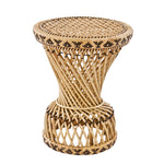 Rattan side table with decorative design.