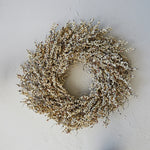 Cream colored faux berry wreath is one of the top wreathes of the 2023 holiday season. 