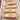 Row of apple tarts on a wooden board with a rustic background