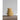 Stack of ceramic lemon shaped measuring cups on a wooden surface with a neutral background