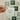 Hand holding a card with a motivational quote against a wall of similar cards.