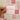 Hand holding a pink card with motivational text against a tiled wall background