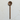 Wooden spoon with a perforated  head on a light marble surface