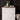 White dresser - painted using Fusion Mineral Pain Snowdrop - with decorative items against a dark paneled wall.
