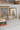 Framed winter-themed prints on a shelf with books and decorative items.