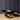 Three metallic bowls on a wooden surface with a dark paneled wall background