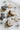 Halloween-themed cookies shaped like ghosts, pumpkins, and bats on a white surface with spider decorations.