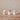 Three ceramic hot chocolate mugs with decorative patterns on a wooden surface.