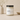 Candle jar with a label on a neutral background