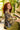 Woman with red hair playing a piano surrounded by greenery