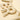 Cream-colored felt letter garland spelling 'VERY MERRY', shown in a close-up shot against a matching cream background.