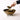 Hand holding a small brass bowl over a larger brass bowl on a white background