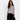 Woman wearing a gray top and black skirt on a white background