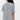 Person wearing a gray oversized shirt with a white background