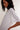 Woman wearing a white t-shirt against a plain background
