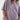 Person wearing a loose-fitting purple shirt and jeans on a white background