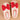 Pair of white slippers with red bows on a beige background
