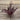 Artificial purple leaf branch on a wooden surface