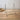 Large sized brass-finished metal wire easel stand for displaying books, frames, or art, shown against a white background.