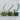 Wooden spools of green velvet ribbon in light, medium, and dark shades.