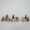 Set of three antique metal houses with sisal trees on tabletop. 