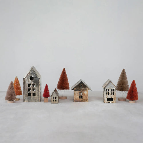 Set of three antique metal houses with sisal trees on tabletop. 