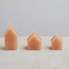 3 sizes of wax candle house in a pale orange colour. 