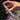 Hand holding a Cinnatizer product with a blurred natural background.