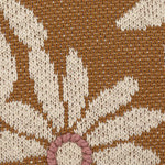 Close up view of the cotton pillow with flowers and embroidery.