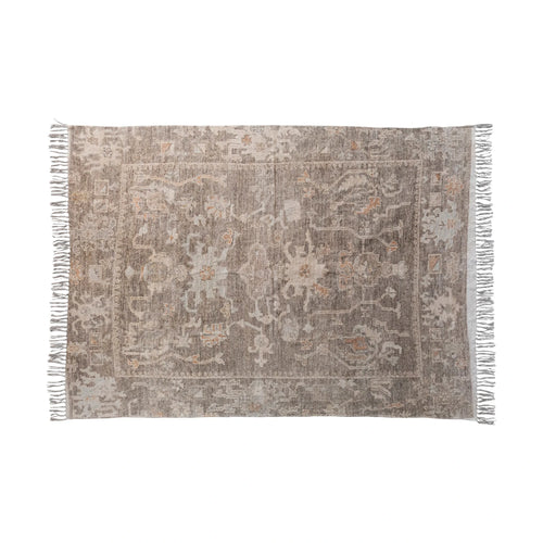 Cotton chenille distressed print rug with fringe on the edges.