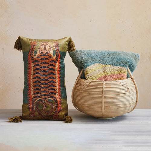 Square cotton pillow in basket pictured beside the beautiful tiger lumbar pillow