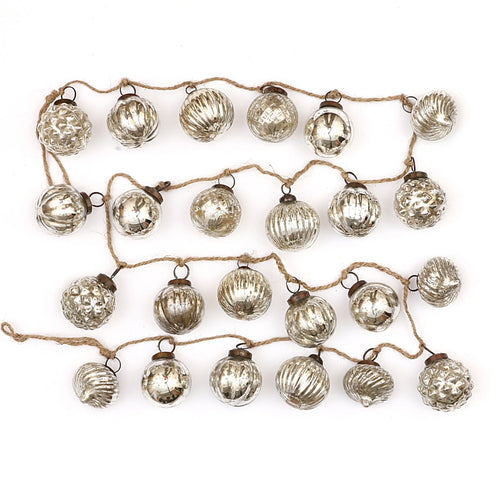 Embossed mercury glass ornament garland on jute string.