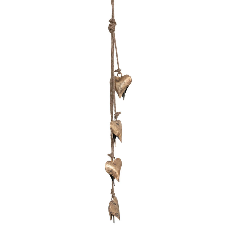 Metal hearts with an antique brass finish, hanging on a jute string.