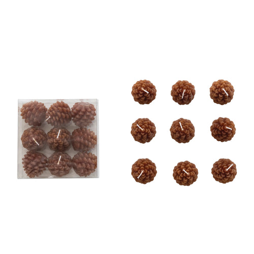Set of nine unscented pinecone shaped tea lights in the color brown. 