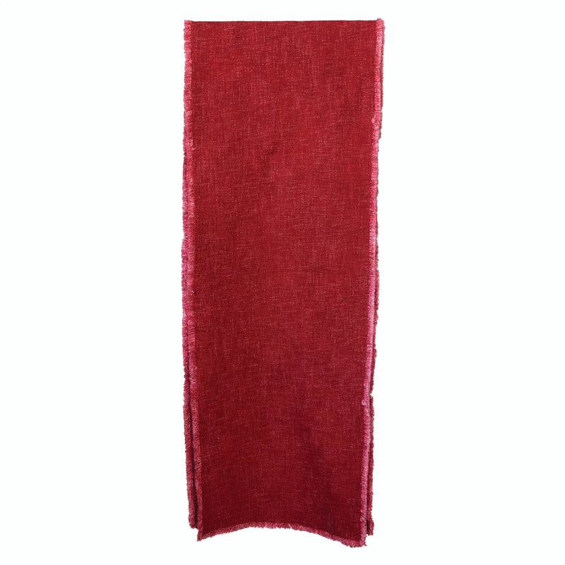 Stylish red linen blend table runner with frayed edges.