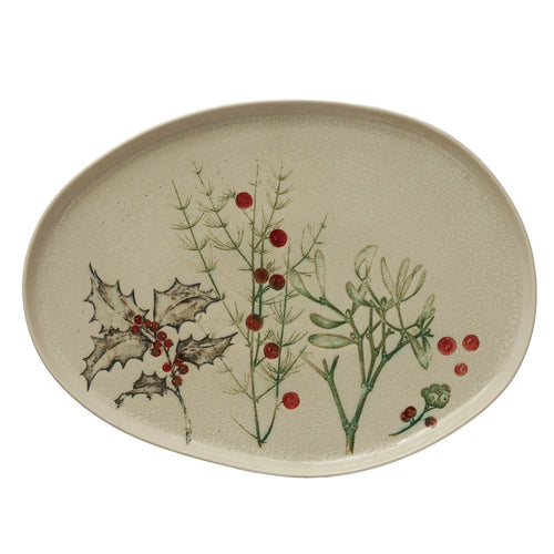 Oval debossed Stoneware platter with seasonal botanicals. Natural off-white color with green and red accents with a reactive crackle glaze finish. 