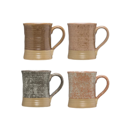 Four different colored stoneware mugs finished with glaze.