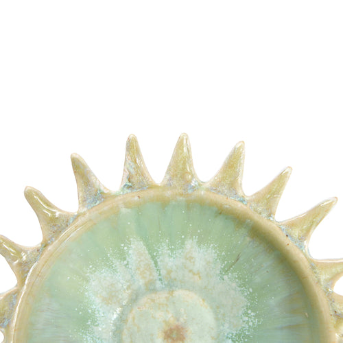 Close up view of the edge of the stoneware sunburst shaped serving bowl.