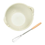 Stoneware bowl and whisk set with wooden handle.
