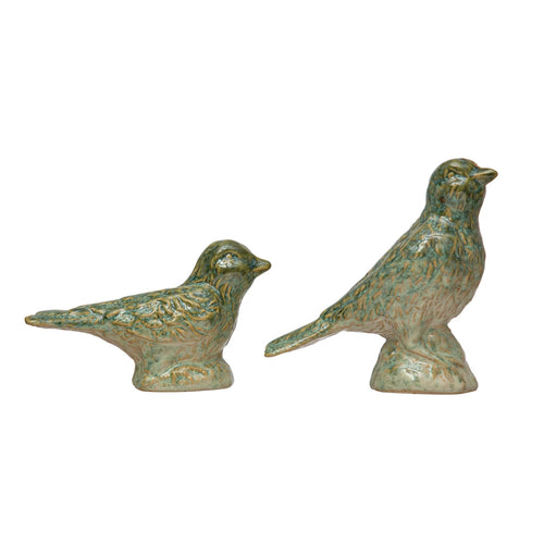 Two debossed stoneware birds with reactive glaze, one sitting, one standing. 